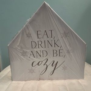 Eat Drink Cozy 12”x12” House Shaped Canvas. Brand new. Still in plastic.
